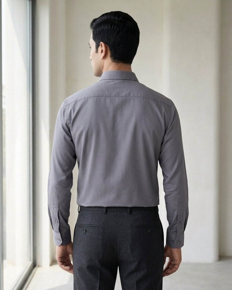 Lifestyle image of man wearing ash grey premium polyester cotton regular fit shirt by Ekrangi