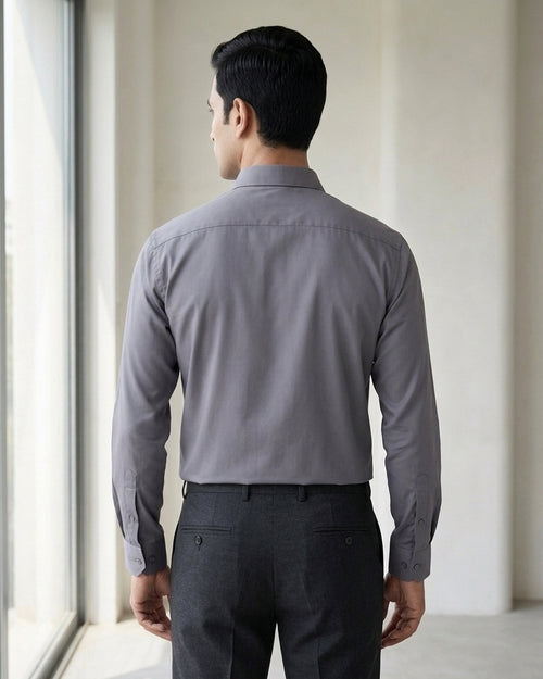 Lifestyle image of man wearing ash grey premium polyester cotton regular fit shirt by Ekrangi