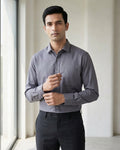 Lifestyle image of man wearing ash grey premium polyester cotton regular fit shirt by Ekrangi