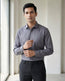 Lifestyle image of man wearing ash grey premium polyester cotton regular fit shirt by Ekrangi