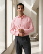 Lifestyle image of man wearing blush pink premium polyester cotton regular fit shirt by Ekrangi