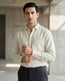 Lifestyle image of man wearing buttercream yelllow premium cotton regular fit shirt by Ekrangi