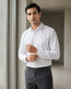Lifestyle image of man wearing dawn yellow premium polyester cotton regular fit shirt by Ekrangi