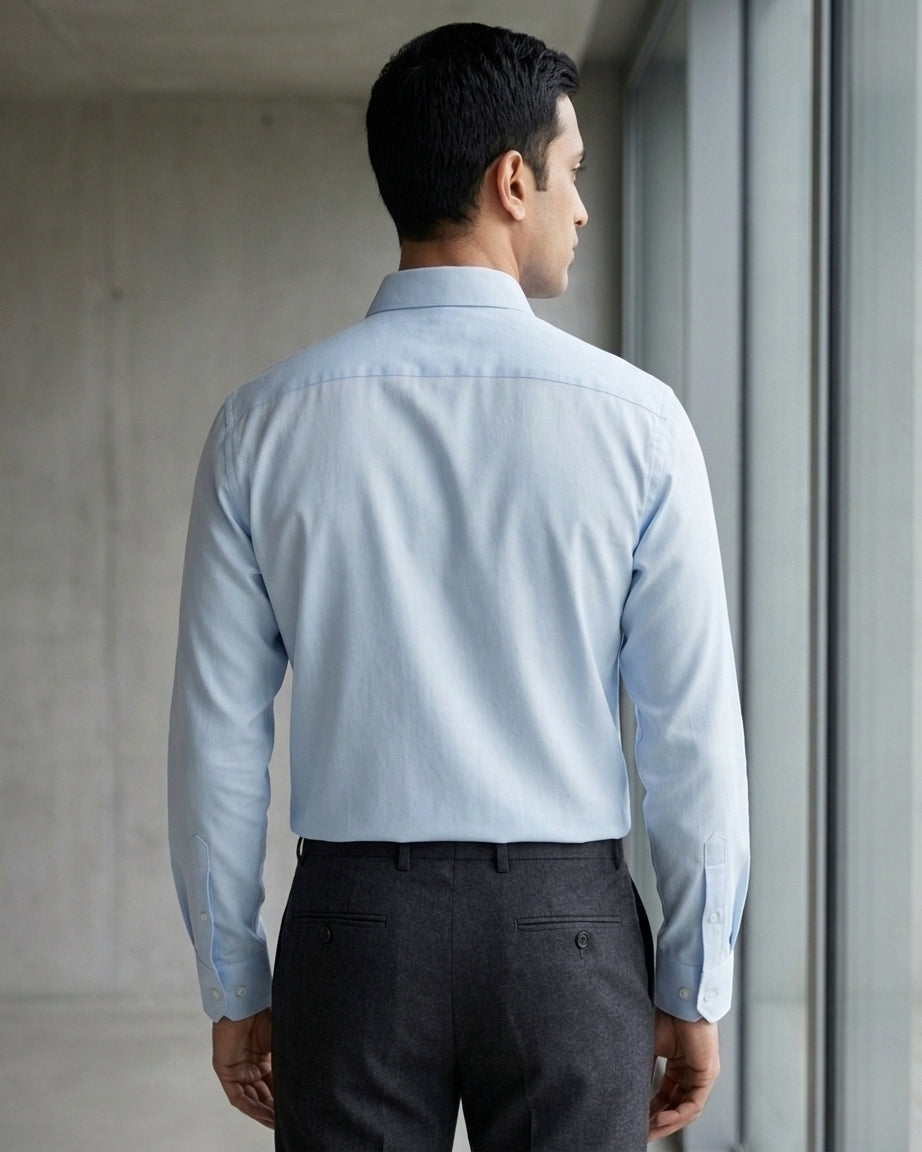 Lifestyle image of man wearing glacier blue cotton sateen regular fit shirt by Ekrangi