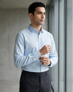 Lifestyle image of man wearing glacier blue cotton sateen regular fit shirt by Ekrangi