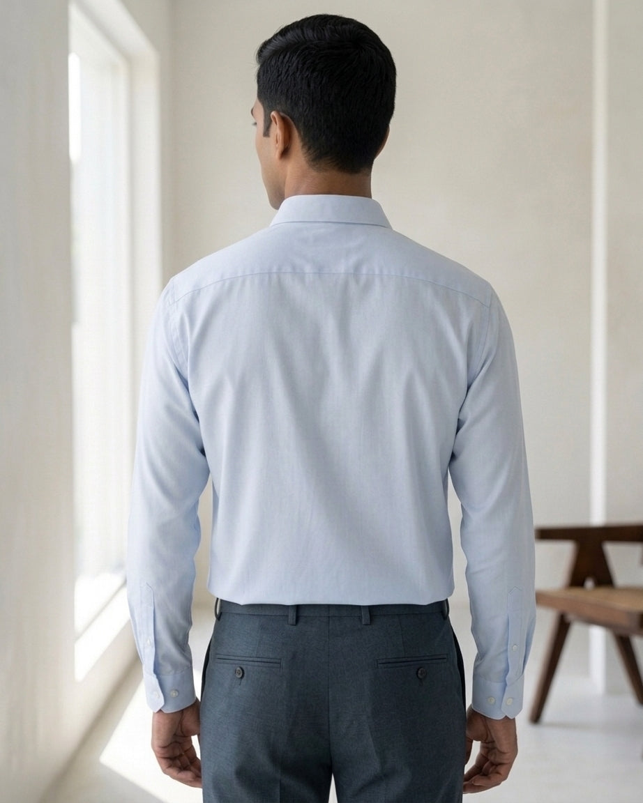 Lifestyle image of man wearing haze blue premium polyester cotton regular fit shirt by Ekrangi