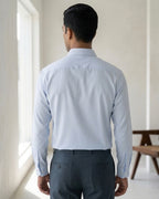 Lifestyle image of man wearing haze blue premium polyester cotton regular fit shirt by Ekrangi