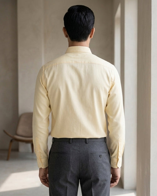 Lifestyle image of man wearing marigold yellow premium cotton regular fit shirt by Ekrangi