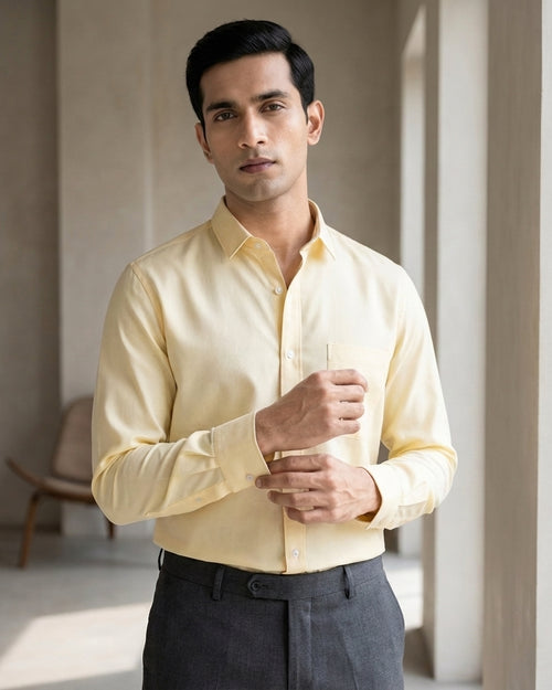 Lifestyle image of man wearing marigold yellow premium cotton regular fit shirt by Ekrangi
