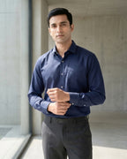 Lifestyle image of man wearing obsidian blue premium polyester cotton regular fit shirt by Ekrangi
