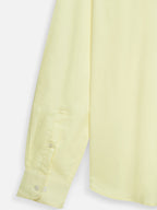 Close-up of fabric of men’s sunlit yellow cotton sateen shirt by Ekrangi