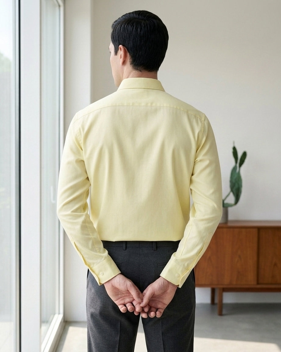 Lifestyle image of man wearing sunlit yellow cotton sateen regular fit shirt by Ekrangi