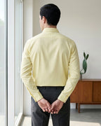Lifestyle image of man wearing sunlit yellow cotton sateen regular fit shirt by Ekrangi